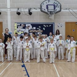 Group photo of students who passed coloured belt grading
